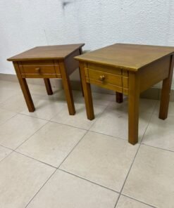 Two classic, medium-toned wooden side tables featuring a single drawer with a round wooden knob and classic grooved detailing on the frame. - Image 5