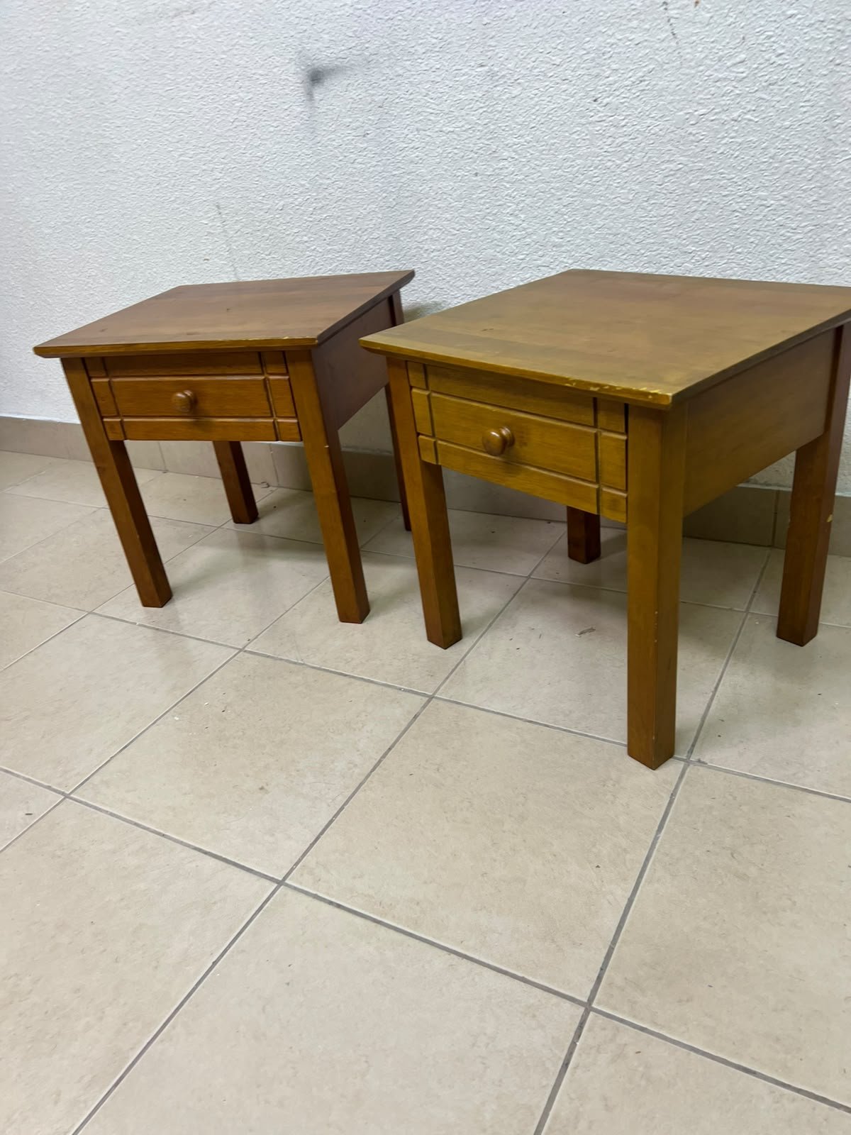 Two classic, medium-toned wooden side tables featuring a single drawer with a round wooden knob and classic grooved detailing on the frame. - Image 5