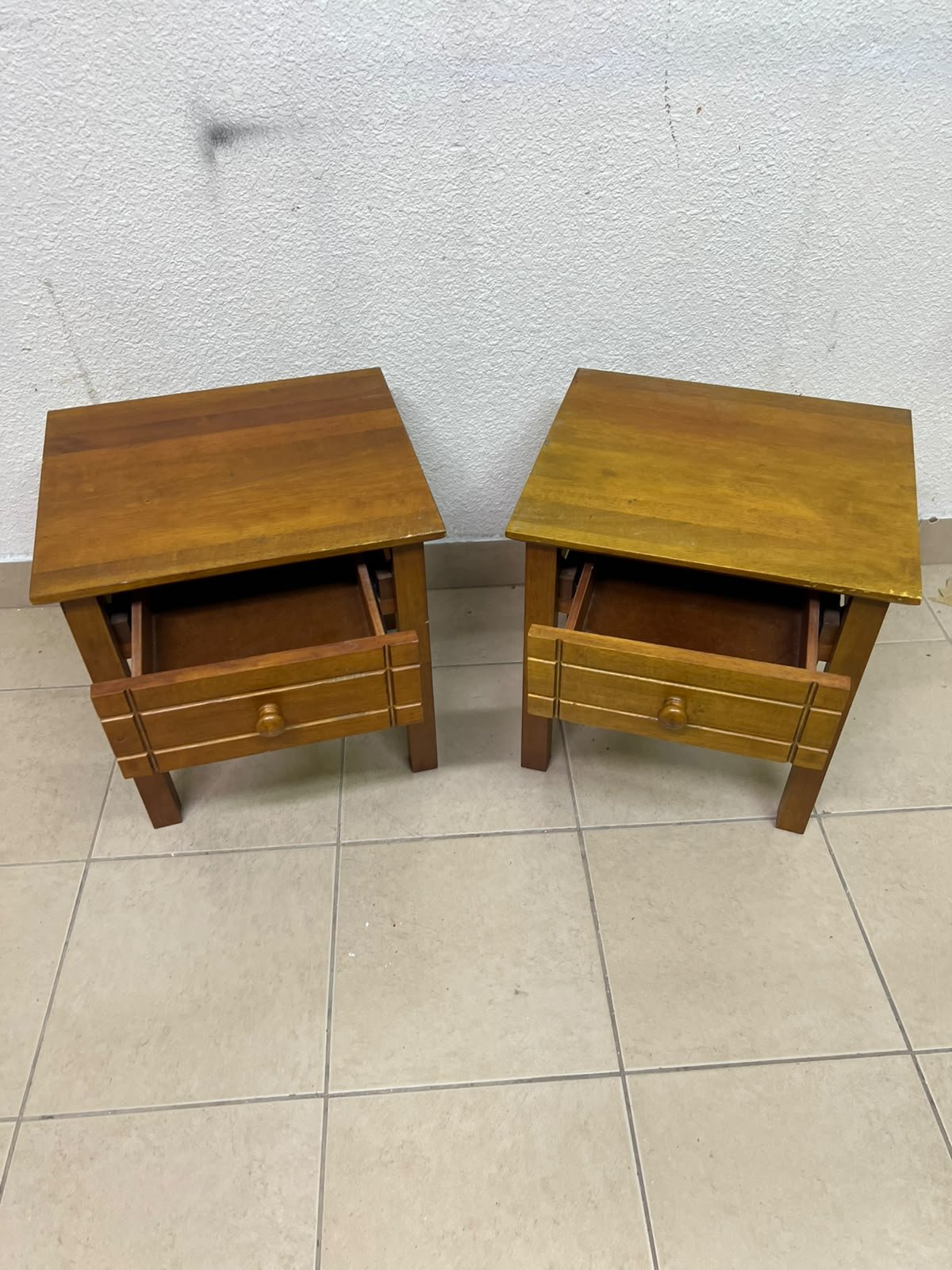 Two classic, medium-toned wooden side tables featuring a single drawer with a round wooden knob and classic grooved detailing on the frame. - Image 6