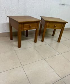 Two classic, medium-toned wooden side tables featuring a single drawer with a round wooden knob and classic grooved detailing on the frame. - Image 7