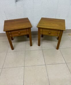 Two classic, medium-toned wooden side tables featuring a single drawer with a round wooden knob and classic grooved detailing on the frame. - Image 8
