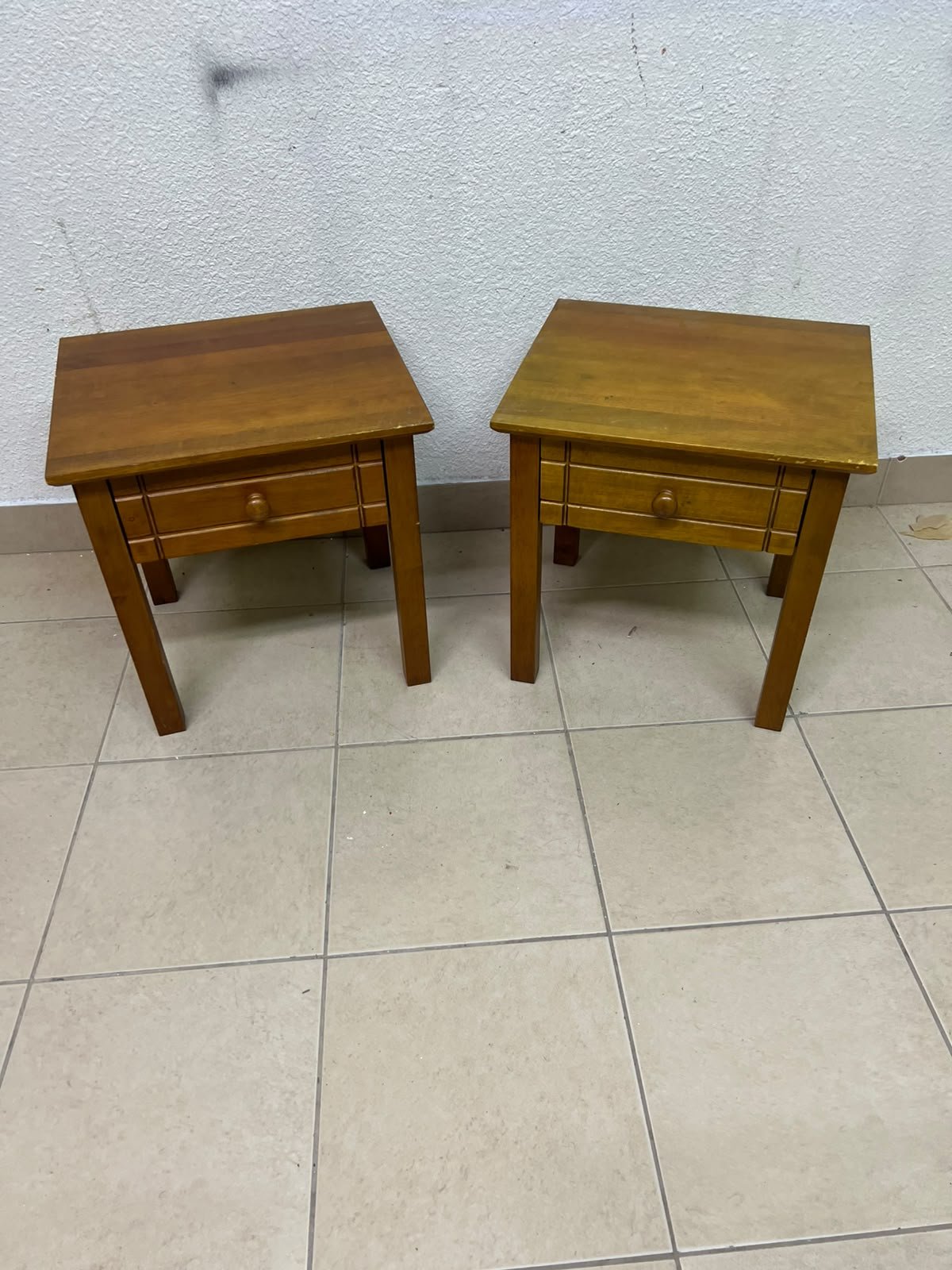 Two classic, medium-toned wooden side tables featuring a single drawer with a round wooden knob and classic grooved detailing on the frame. - Image 8
