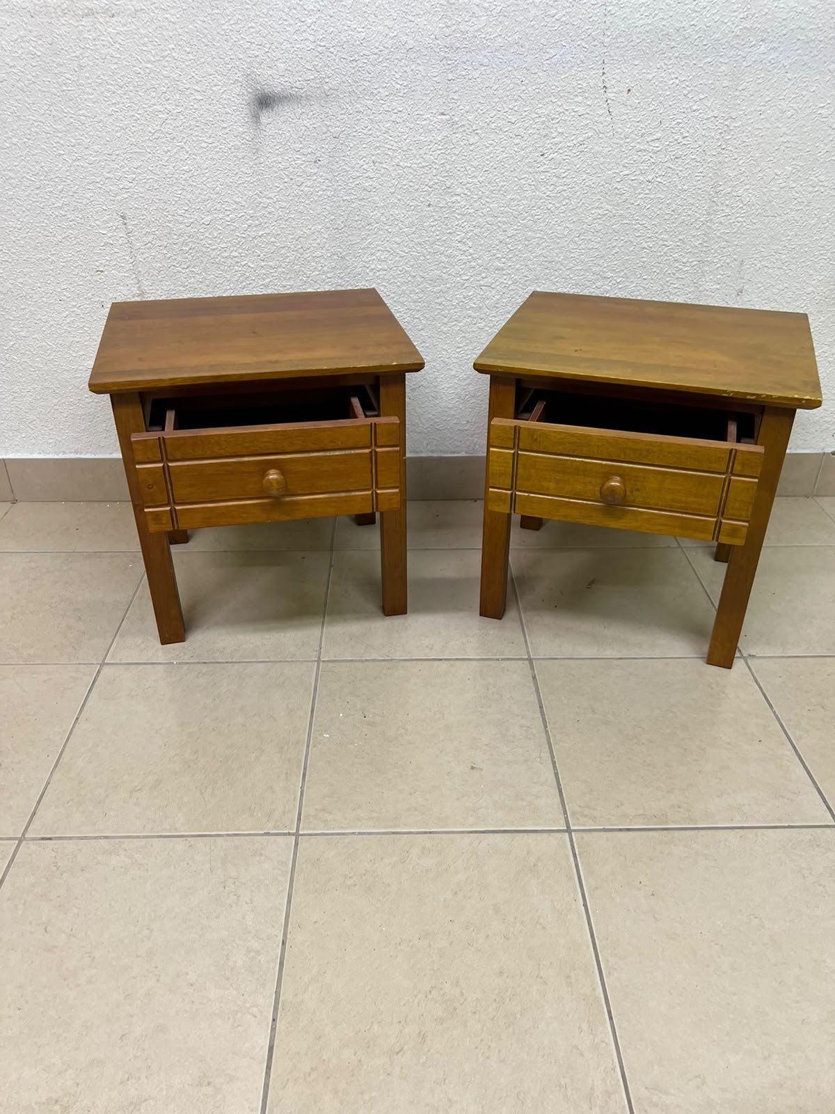 Two classic, medium-toned wooden side tables featuring a single drawer with a round wooden knob and classic grooved detailing on the frame. - Image 10