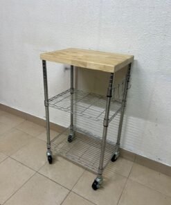 A multi-shelf kitchen cart made of chrome wire, featuring a light-colored wood top (butcher block style) and swivel casters.