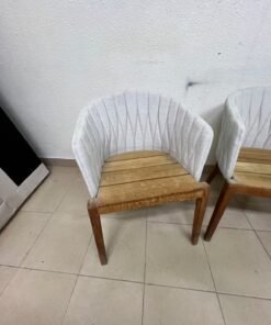 The "Calypso" garden chair by Royal Botania, featuring a solid teak base and an upholstered backrest with a unique design incorporating vertical stitching. - Image 4