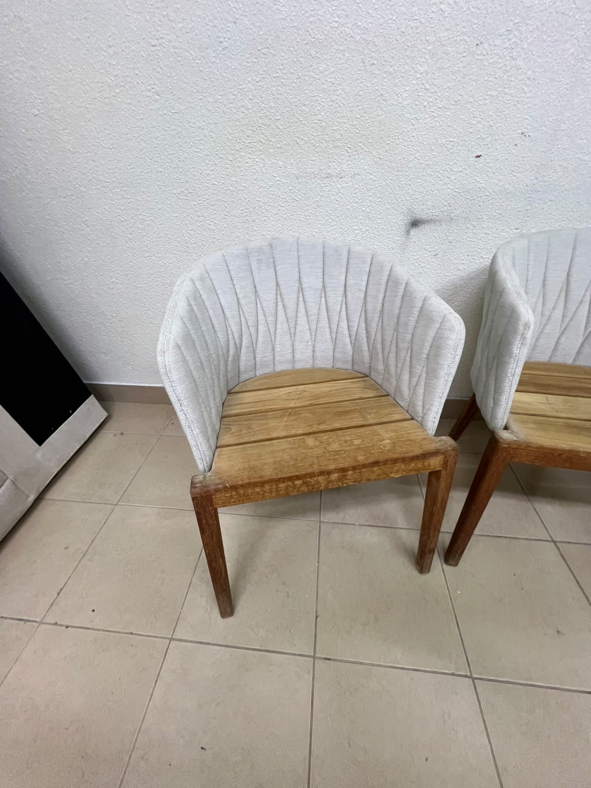 The "Calypso" garden chair by Royal Botania, featuring a solid teak base and an upholstered backrest with a unique design incorporating vertical stitching. - Image 4