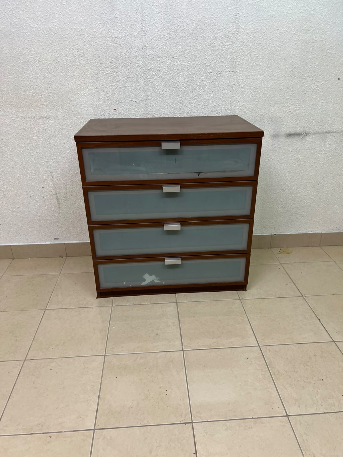 The IKEA HOPEN dark wood chest of drawers features four drawers with frosted glass fronts and silver-colored handles. - Image 2