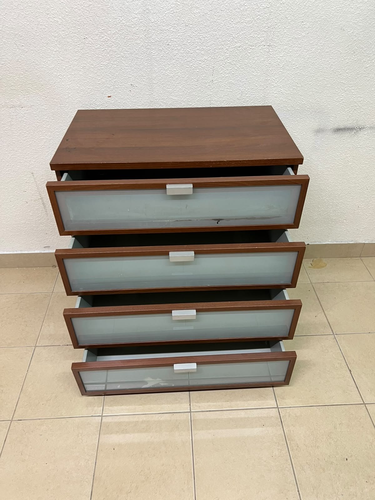 The IKEA HOPEN dark wood chest of drawers features four drawers with frosted glass fronts and silver-colored handles. - Image 3