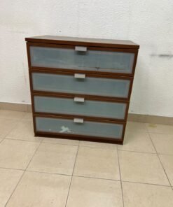 The IKEA HOPEN dark wood chest of drawers features four drawers with frosted glass fronts and silver-colored handles.