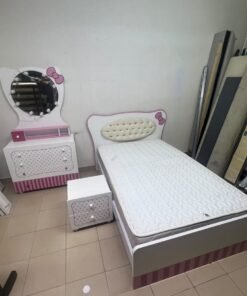 A girls' bedroom featuring a white and pink color scheme, including a bed with bedding, a storage table with an illuminated mirror, and a bedside table. - Image 6