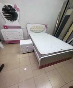 A girls' bedroom featuring a white and pink color scheme, including a bed with bedding, a storage table with an illuminated mirror, and a bedside table. - Image 9