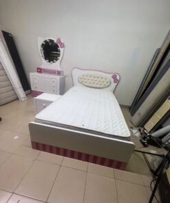 A girls' bedroom featuring a white and pink color scheme, including a bed with bedding, a storage table with an illuminated mirror, and a bedside table. - Image 10
