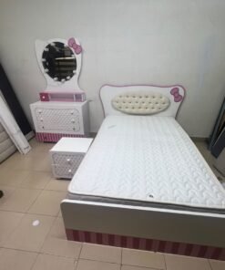 A girls' bedroom featuring a white and pink color scheme, including a bed with bedding, a storage table with an illuminated mirror, and a bedside table. - Image 11