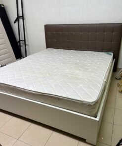 A modern white wooden king-size bed, paired with a cushioned spring mattress and a brown faux-leather upholstered headboard. - Image 9