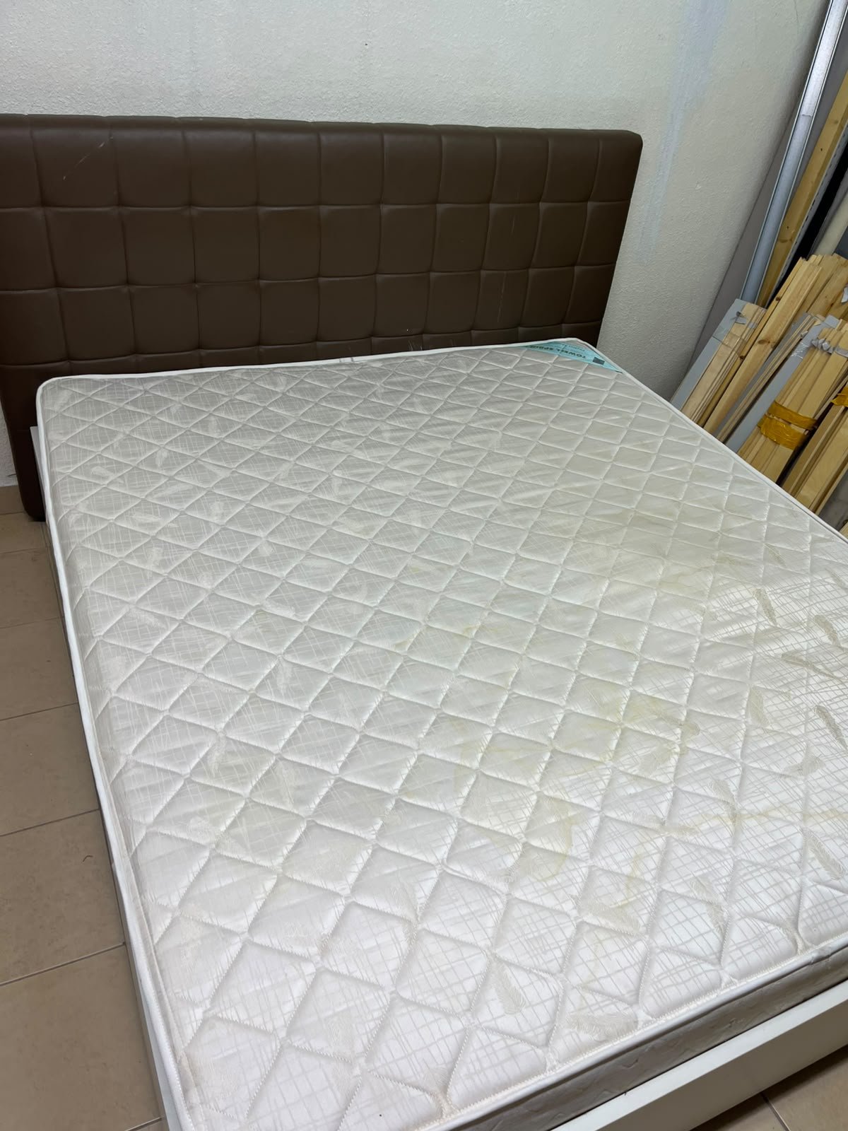 A modern white wooden king-size bed, paired with a cushioned spring mattress and a brown faux-leather upholstered headboard. - Image 2