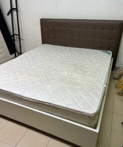 A modern white wooden king-size bed, paired with a cushioned spring mattress and a brown faux-leather upholstered headboard. - Image 4