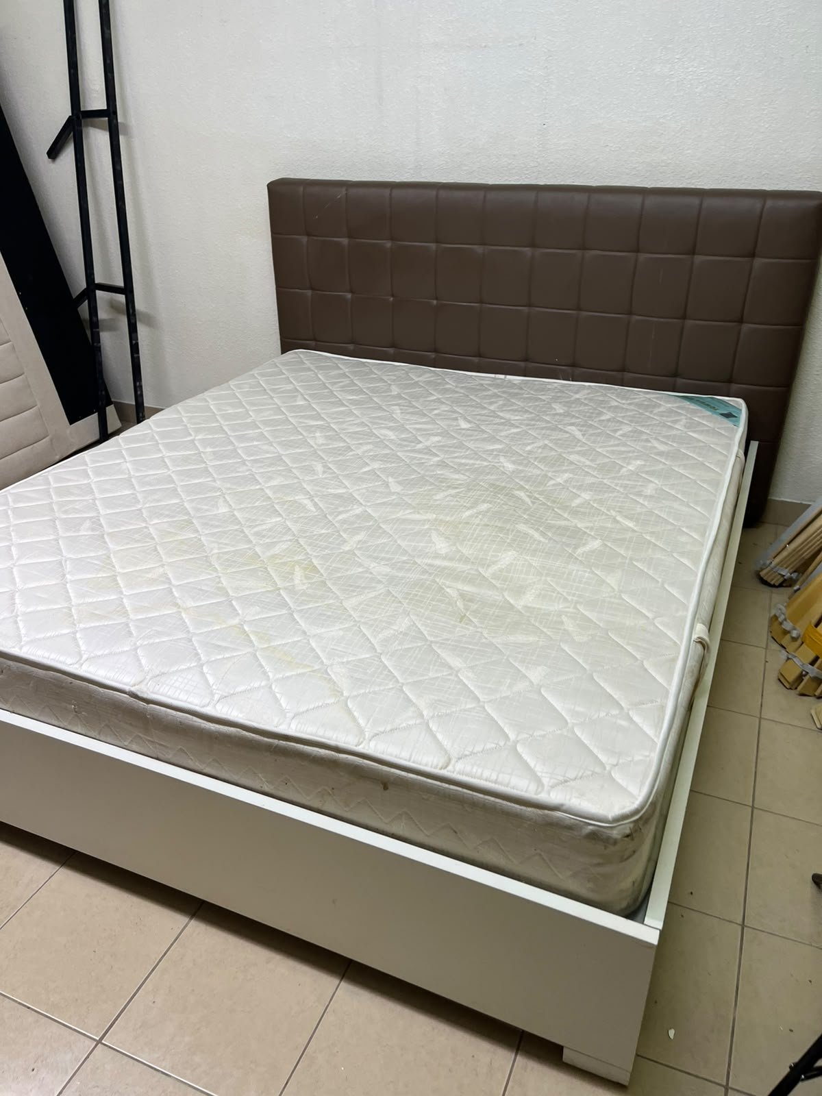 A modern white wooden king-size bed, paired with a cushioned spring mattress and a brown faux-leather upholstered headboard. - Image 4