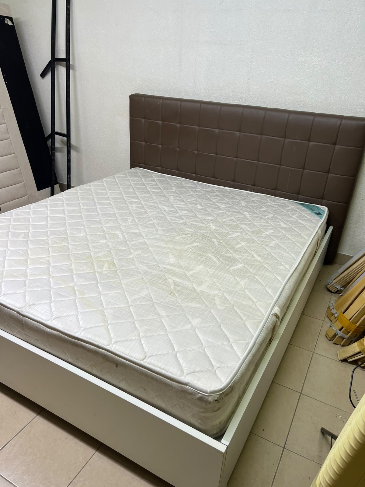 A modern white wooden king-size bed, paired with a cushioned spring mattress and a brown faux-leather upholstered headboard. - Image 8