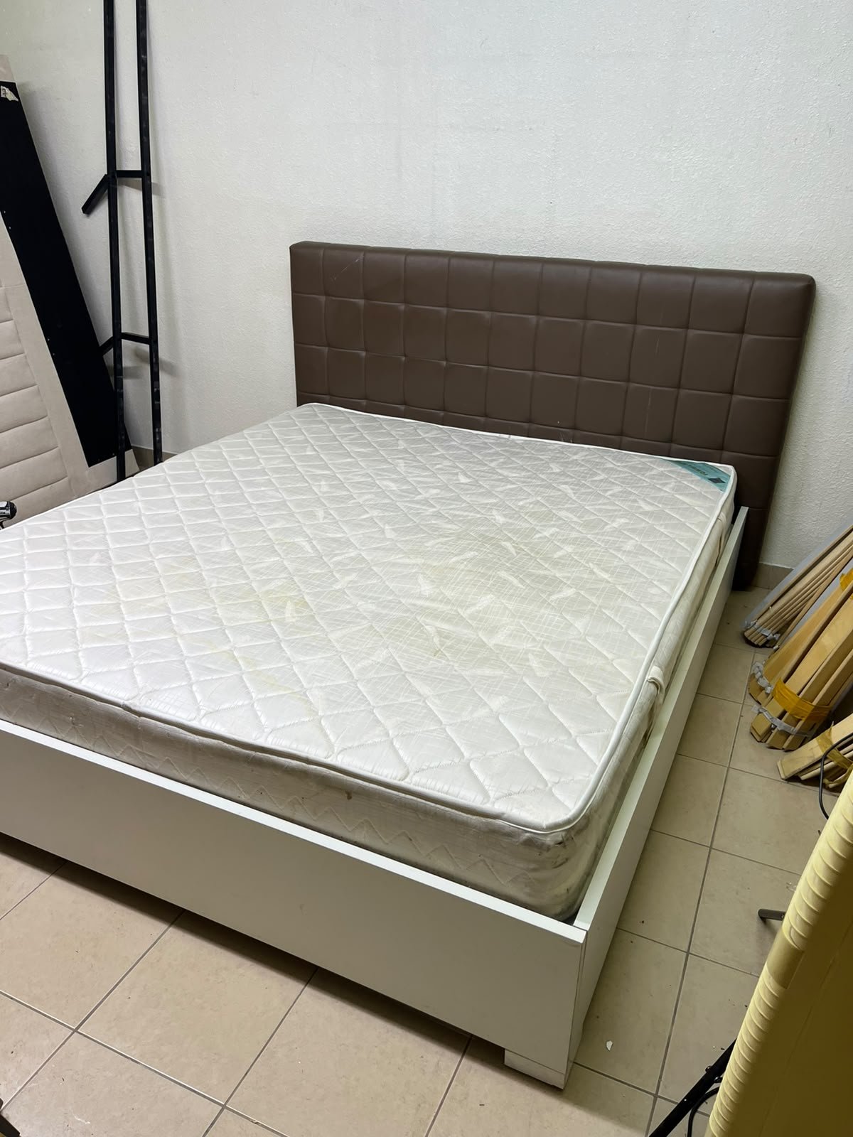 A modern white wooden king-size bed, paired with a cushioned spring mattress and a brown faux-leather upholstered headboard. - Image 7