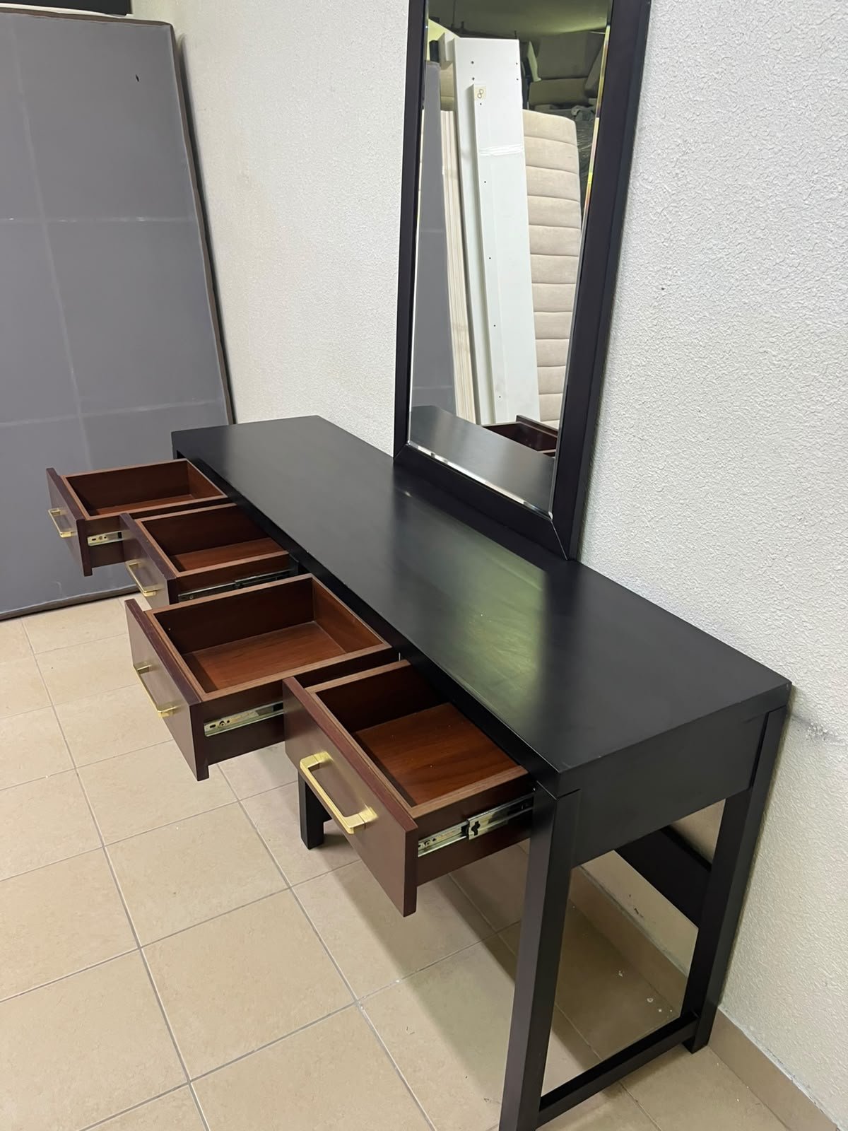 An ultra-long, modern console or vanity table featuring a black wooden frame, contrasting warm-toned wooden drawers, and gold-finished metal handles; it comes with a matching wall mirror. - Image 12