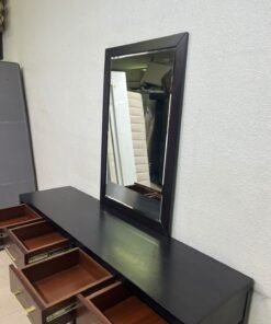 An ultra-long, modern console or vanity table featuring a black wooden frame, contrasting warm-toned wooden drawers, and gold-finished metal handles; it comes with a matching wall mirror. - Image 13