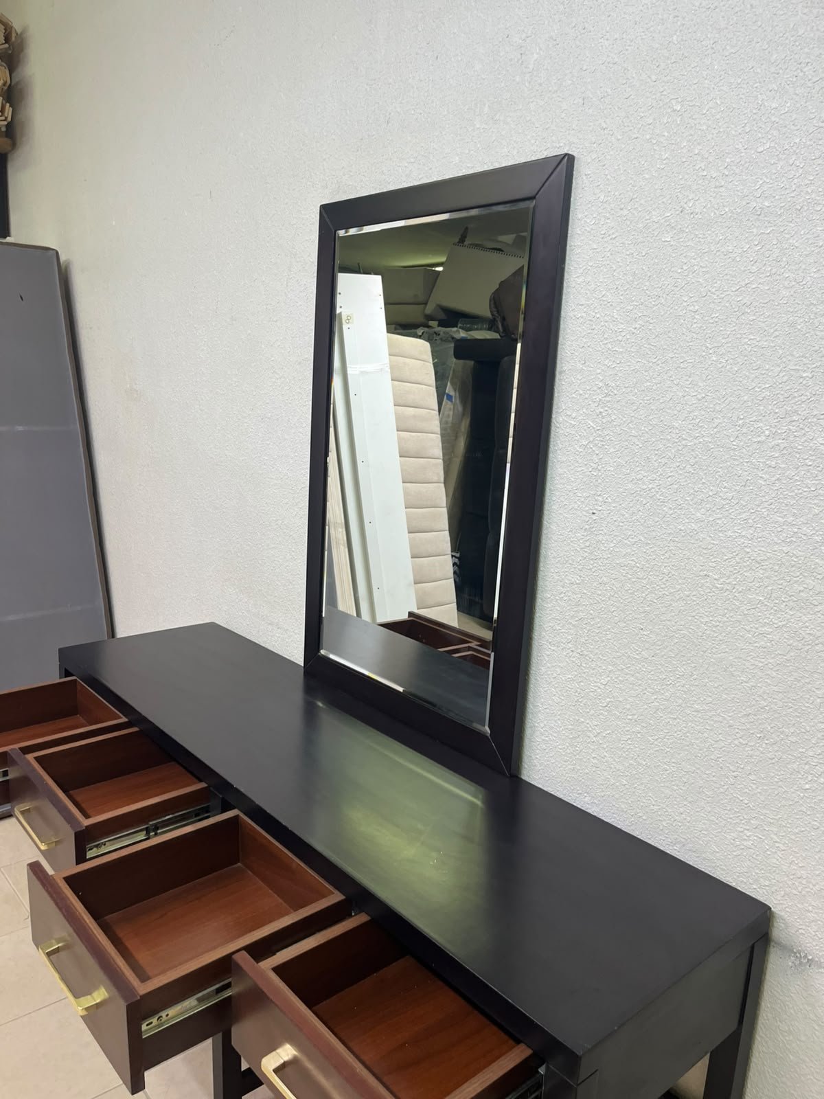 An ultra-long, modern console or vanity table featuring a black wooden frame, contrasting warm-toned wooden drawers, and gold-finished metal handles; it comes with a matching wall mirror. - Image 13