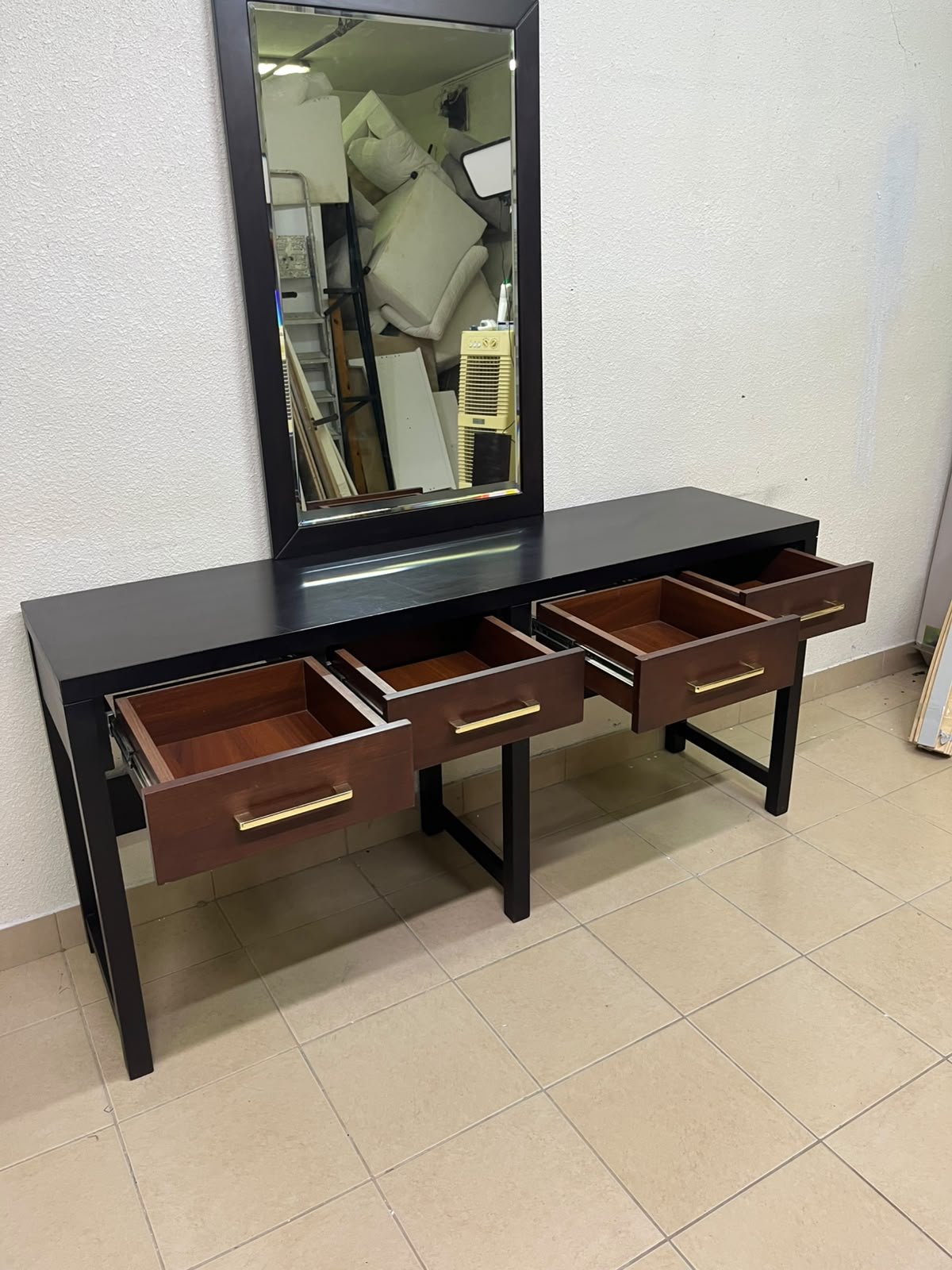 An ultra-long, modern console or vanity table featuring a black wooden frame, contrasting warm-toned wooden drawers, and gold-finished metal handles; it comes with a matching wall mirror. - Image 14