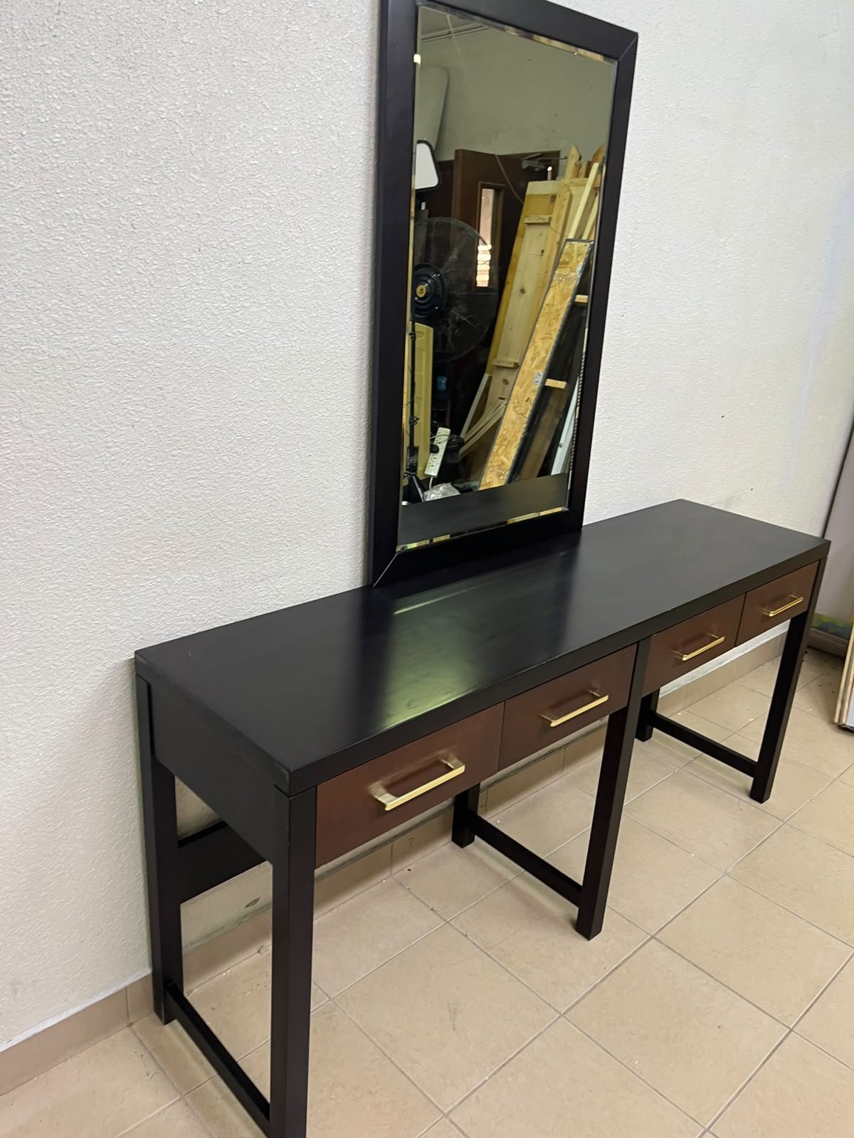 An ultra-long, modern console or vanity table featuring a black wooden frame, contrasting warm-toned wooden drawers, and gold-finished metal handles; it comes with a matching wall mirror. - Image 3