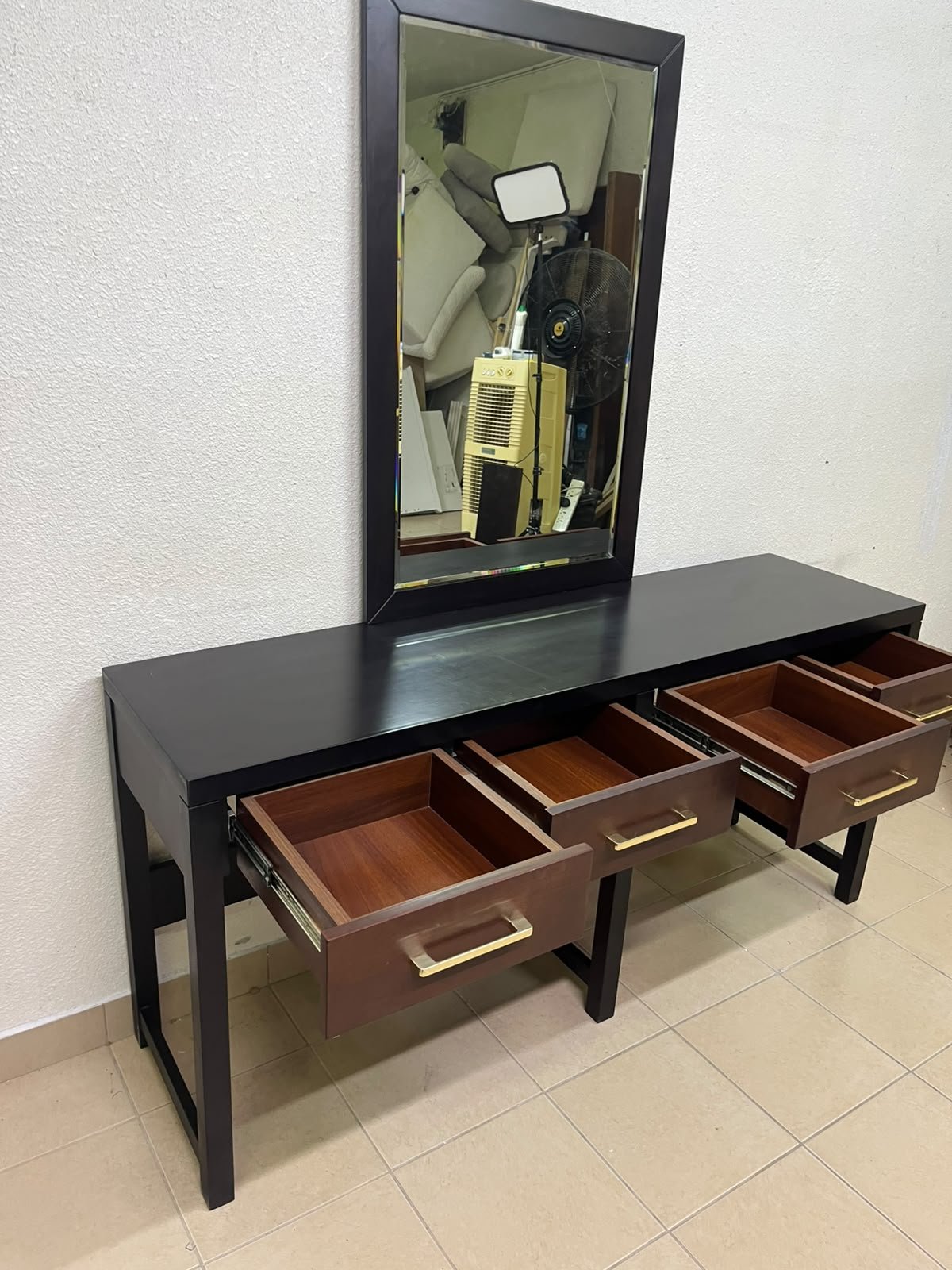 An ultra-long, modern console or vanity table featuring a black wooden frame, contrasting warm-toned wooden drawers, and gold-finished metal handles; it comes with a matching wall mirror. - Image 5
