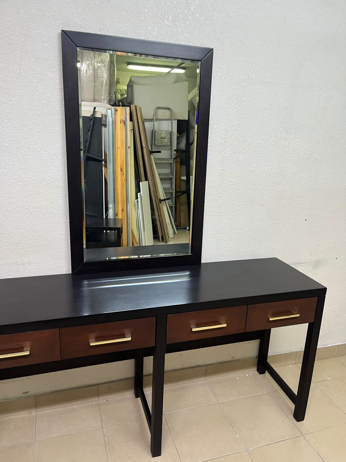 An ultra-long, modern console or vanity table featuring a black wooden frame, contrasting warm-toned wooden drawers, and gold-finished metal handles; it comes with a matching wall mirror. - Image 7