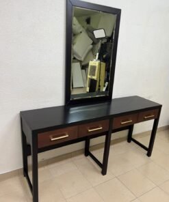 An ultra-long, modern console or vanity table featuring a black wooden frame, contrasting warm-toned wooden drawers, and gold-finished metal handles; it comes with a matching wall mirror.