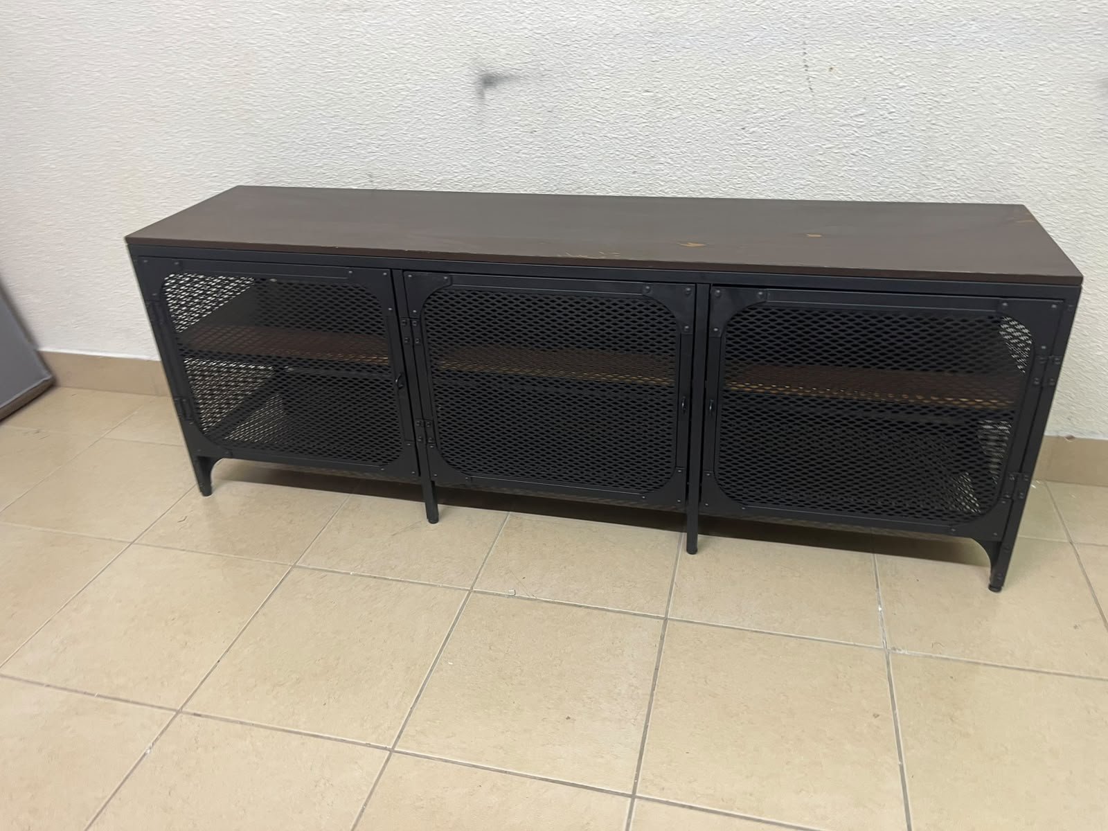 The FJÄLLBO TV unit from IKEA, featuring an industrial design with a solid wood top and black metal mesh doors. - Image 4