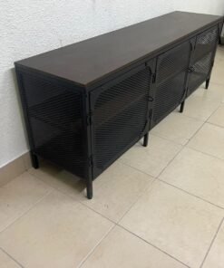 The FJÄLLBO TV unit from IKEA, featuring an industrial design with a solid wood top and black metal mesh doors.