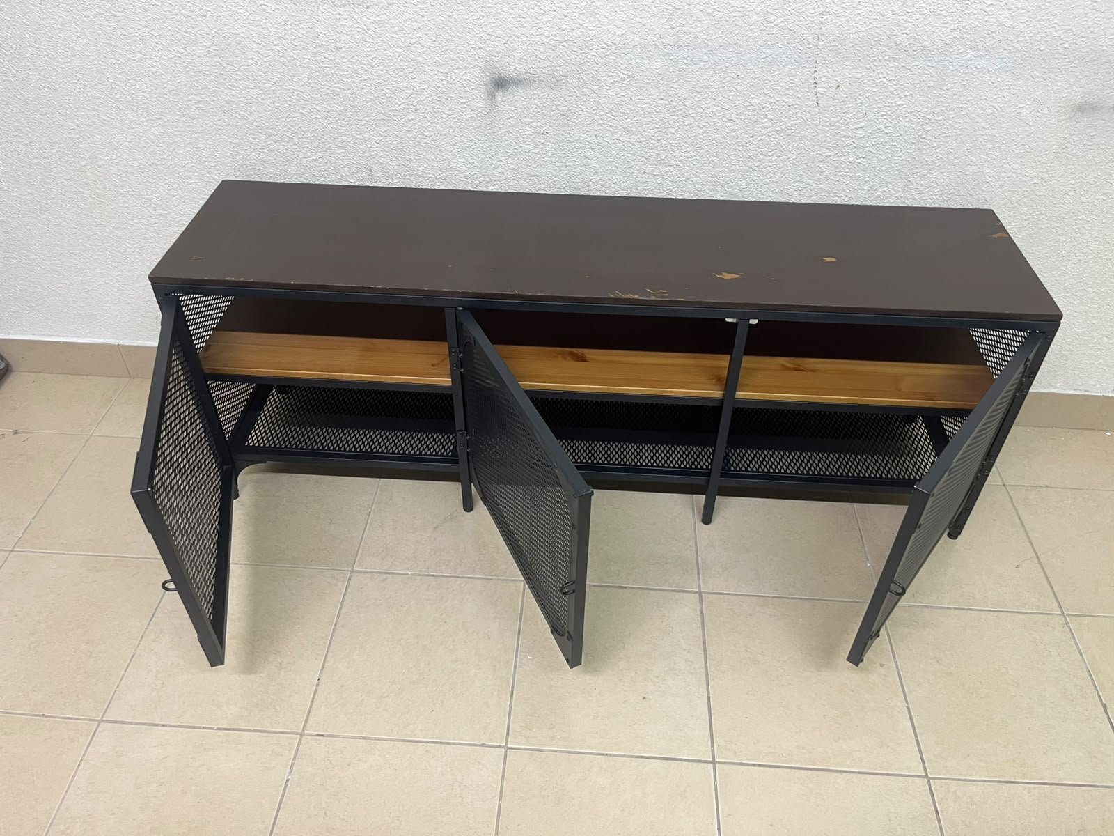 The FJÄLLBO TV unit from IKEA, featuring an industrial design with a solid wood top and black metal mesh doors. - Image 8