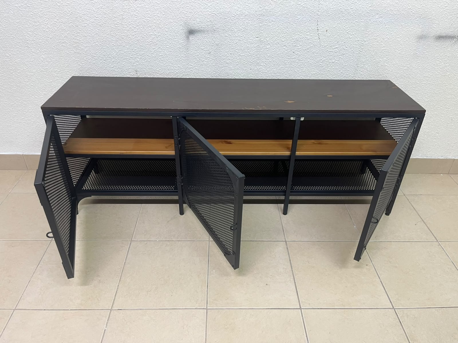 The FJÄLLBO TV unit from IKEA, featuring an industrial design with a solid wood top and black metal mesh doors. - Image 9