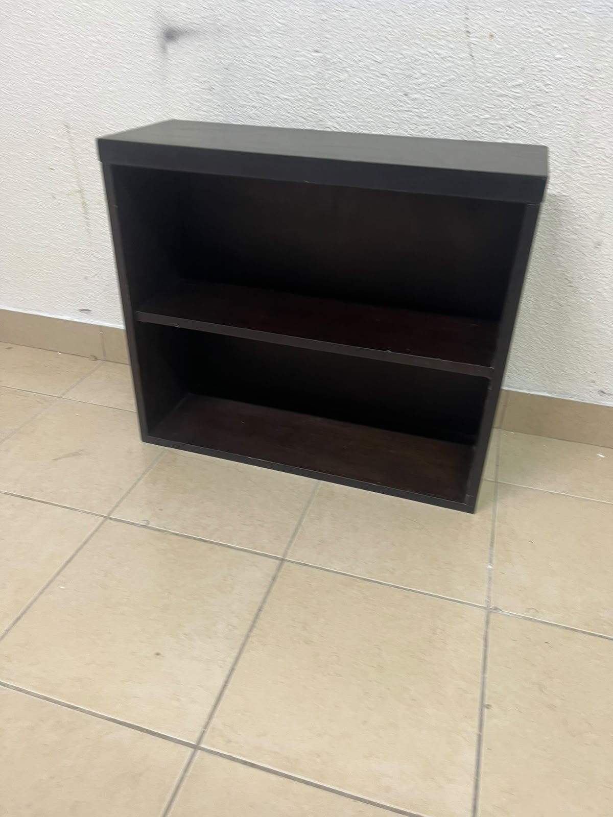 A wall-mounted, open-style bookcase featuring two shelves and a sleek rectangular design, crafted from wood in a dark brown or "espresso" finish.