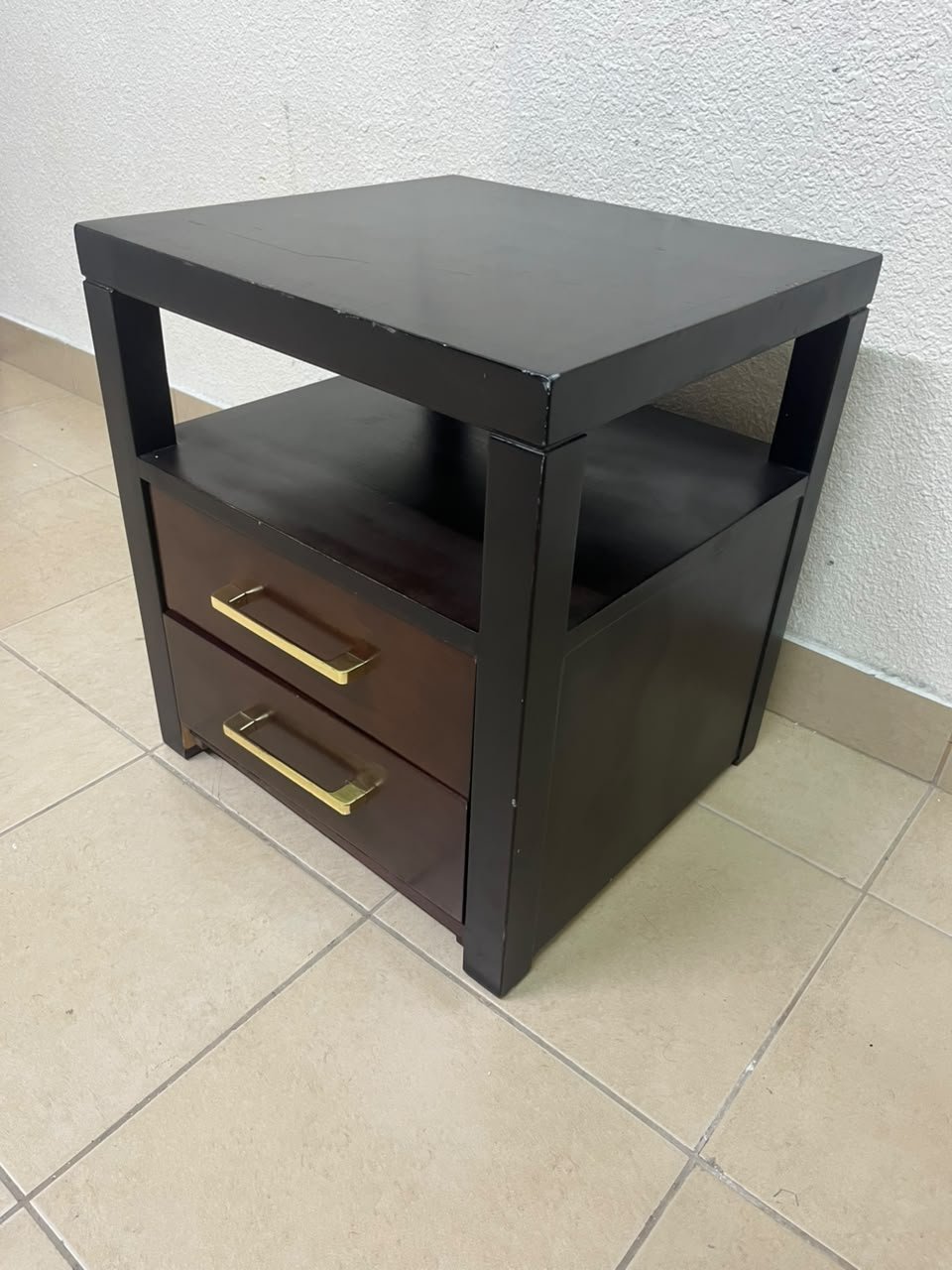 A modern wooden side table featuring two drawers and an open shelf, with a dark wood frame that contrasts with the reddish-brown drawer fronts, accented by slender metal handles. - Image 12