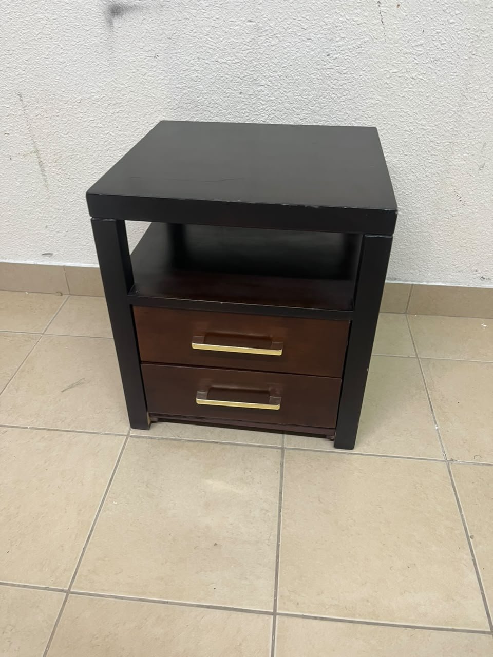 A modern wooden side table featuring two drawers and an open shelf, with a dark wood frame that contrasts with the reddish-brown drawer fronts, accented by slender metal handles. - Image 2