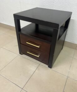 A modern wooden side table featuring two drawers and an open shelf, with a dark wood frame that contrasts with the reddish-brown drawer fronts, accented by slender metal handles.