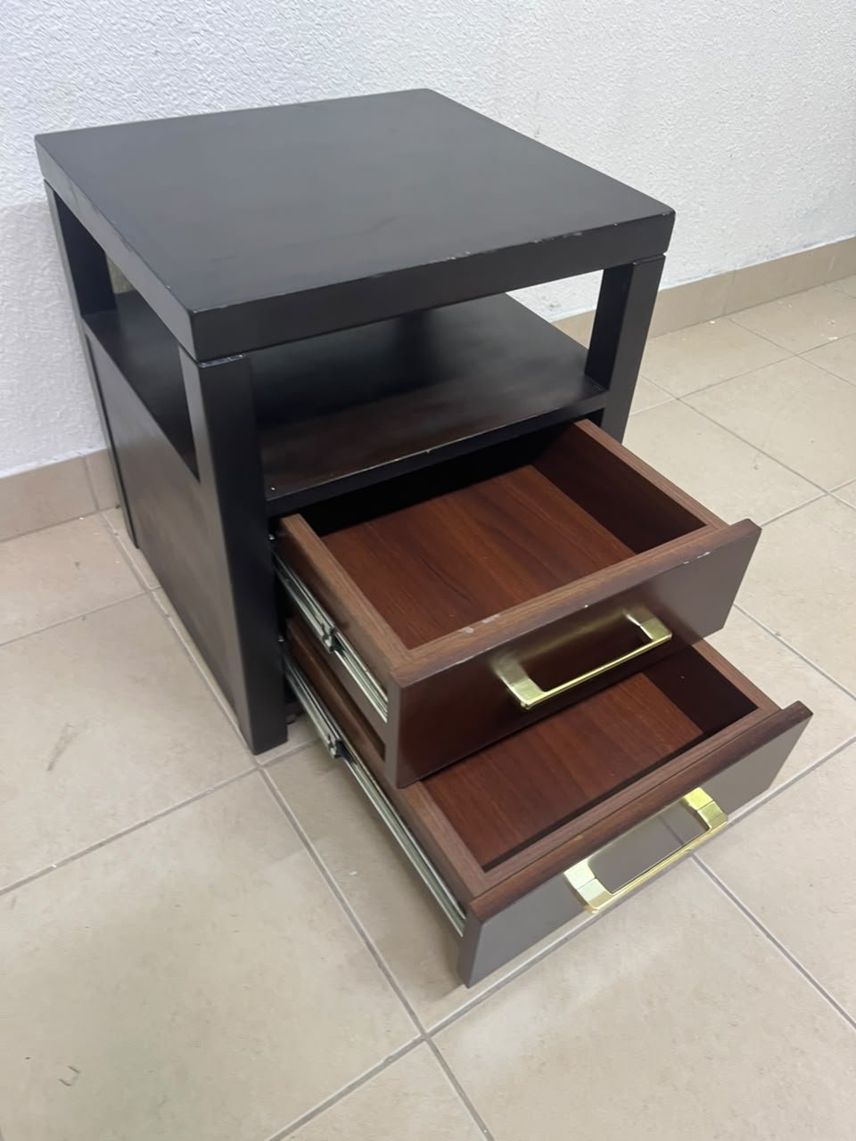 A modern wooden side table featuring two drawers and an open shelf, with a dark wood frame that contrasts with the reddish-brown drawer fronts, accented by slender metal handles. - Image 5