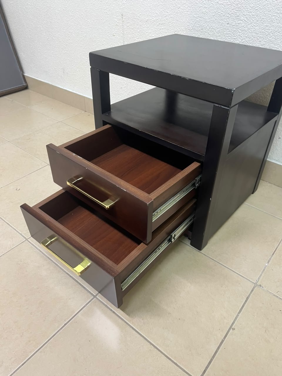 A modern wooden side table featuring two drawers and an open shelf, with a dark wood frame that contrasts with the reddish-brown drawer fronts, accented by slender metal handles. - Image 7