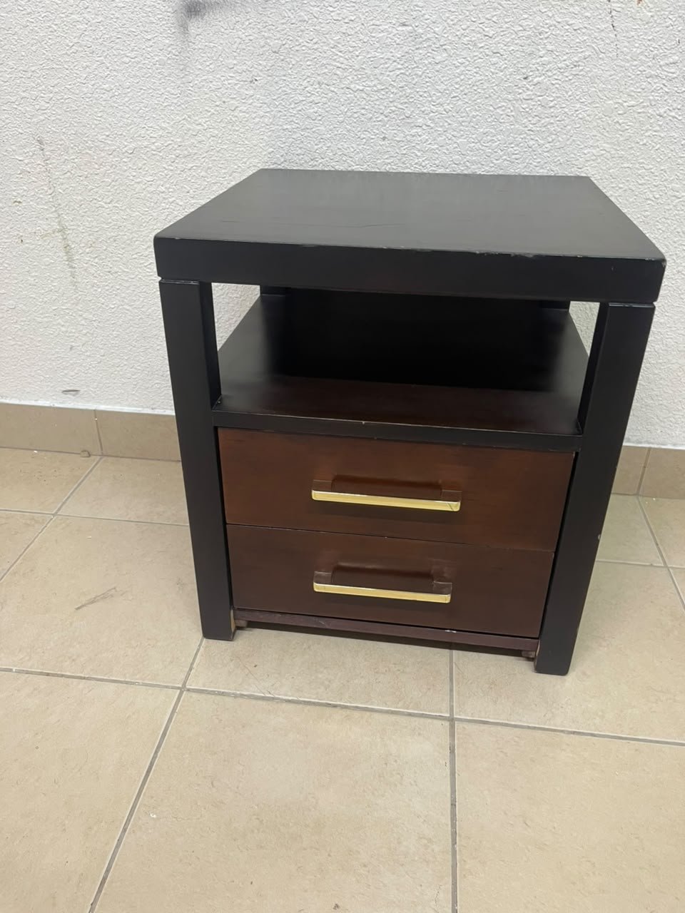 A modern wooden side table featuring two drawers and an open shelf, with a dark wood frame that contrasts with the reddish-brown drawer fronts, accented by slender metal handles. - Image 11