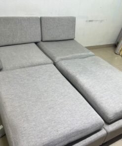 This appears to be a light gray fabric modular sofa, featuring matching ottomans and low, dark block-style legs. - Image 7