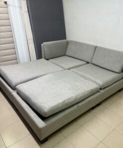 This appears to be a light gray fabric modular sofa, featuring matching ottomans and low, dark block-style legs. - Image 11