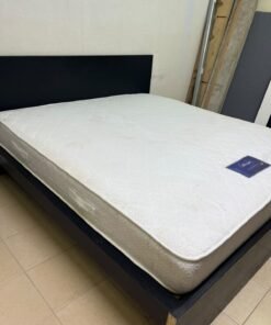 Black IKEA bed with a white "Silentnight Starlight" mattress.