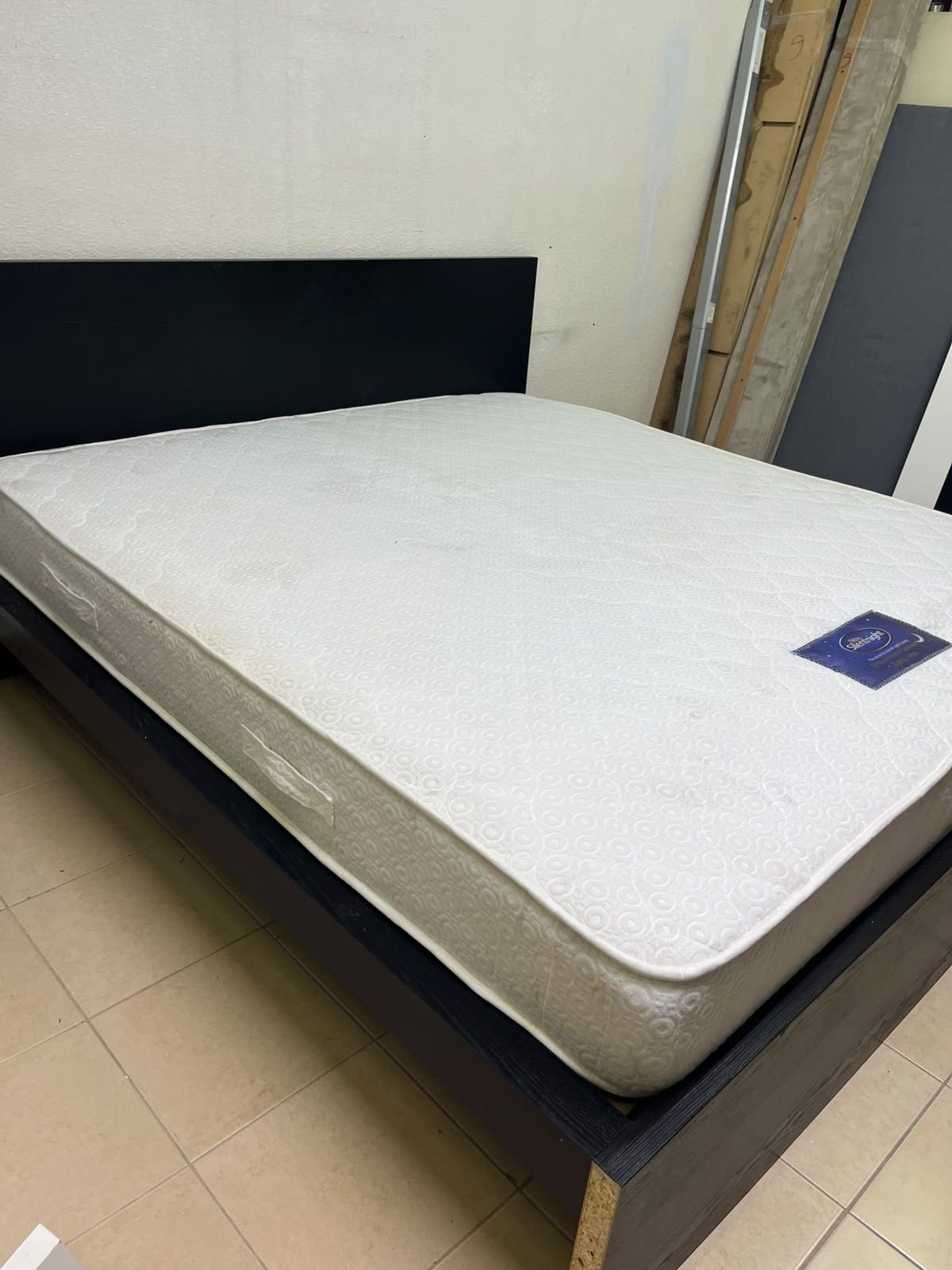 Black IKEA bed with a white "Silentnight Starlight" mattress.