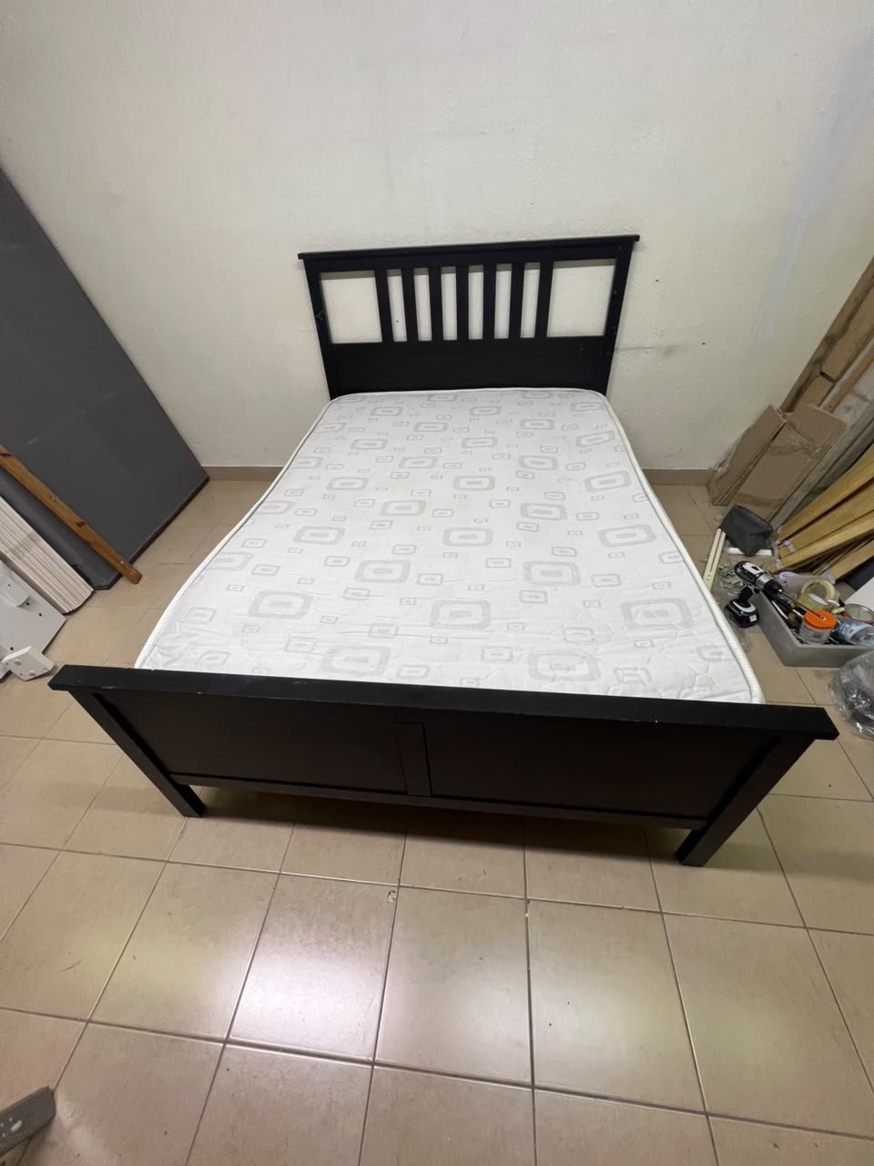 An IKEA "HEMNES" wooden bed frame in a black-brown finish, featuring a slatted headboard and a matching mattress. - Image 5