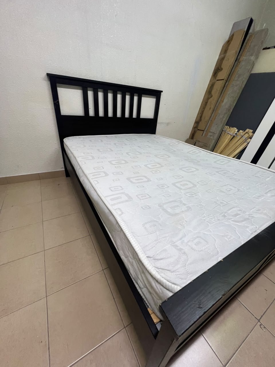 An IKEA "HEMNES" wooden bed frame in a black-brown finish, featuring a slatted headboard and a matching mattress. - Image 6