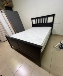 An IKEA "HEMNES" wooden bed frame in a black-brown finish, featuring a slatted headboard and a matching mattress. - Image 8