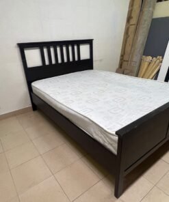 An IKEA "HEMNES" wooden bed frame in a black-brown finish, featuring a slatted headboard and a matching mattress. - Image 9